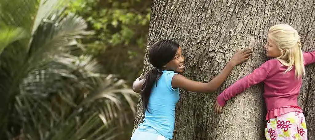 Girls Hugging Tree